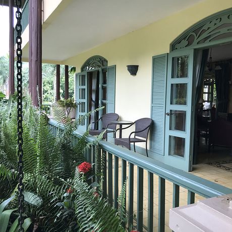 Sitzen Sie auf der Veranda Ihrer Unterkunft.