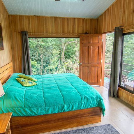 Blick auf ein Doppelbett einer Suite in der Pension Cala Lodge